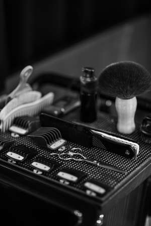 Barber shaving kit and brush lying in box. Set of professional hairdresser toolsの写真素材