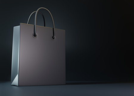 Empty black color shopping bag on the black background, copy space text, creative concept. 3d render illustrationの写真素材