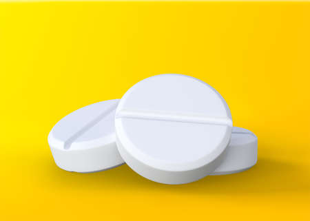 Three white tablets on yellow background, medical treatment, pharmaceutical or medication concept. 3D rendering illustrationの写真素材