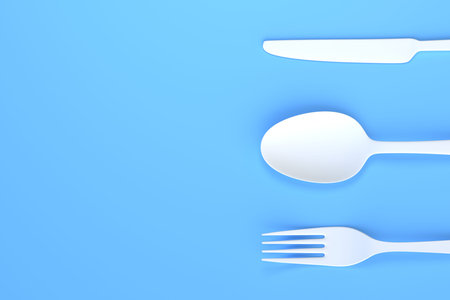 Fork, spoon and knife on blue background. top view. Home kitchen tools and accessories for cooking....