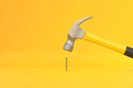 Hammer with a steel head and a yellow plastic handle banging a small screw on yellow background. Front view, minimalism. copyspace. 3d rendering illustrationの写真素材