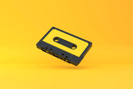 Vintage audio tape cassette on a yellow background. Front view with copy space. 3d rendering illustrationの写真素材