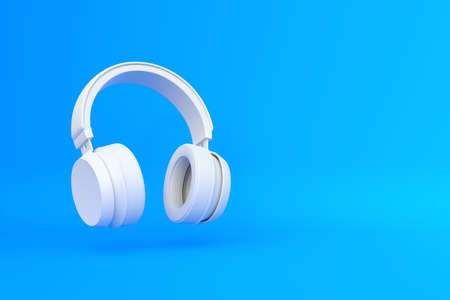 Wireless headphones in the air on a blue background. 3d rendering illustrationの写真素材