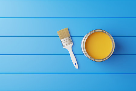An open can of paint and a brush on a blue background in the form of boards. view from above. repair concept. 3d render illustrationの写真素材