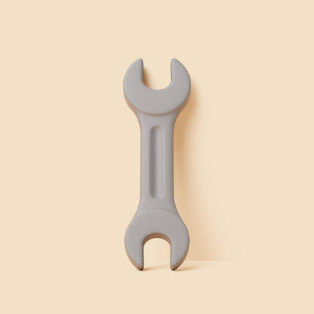 Minimal 3D illustration of a gray double open-end wrench tool isolated on beige background. Hand tool concept for repair or mechanic workの写真素材