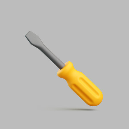 Minimal floating flathead screwdriver with a yellow plastic handle and metallic shaft, isolated on gray backgroundの写真素材