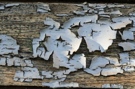 Texture of an old wooden board with peeling paint. Peeling paint close-up.
