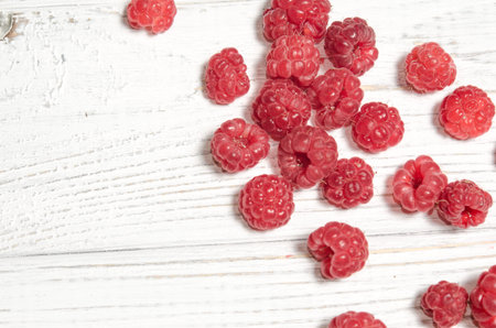 Ripe sweet raspberries on a wooden table. A close-up, high-resolution product. The concept of...