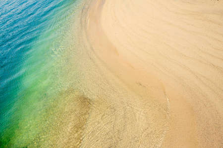 Close up photo of sandy beach with soft wave in motion at Agia Napa Cyprusの写真素材