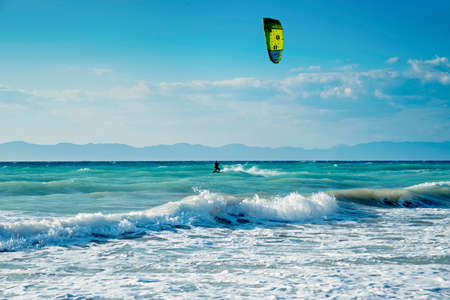 Windsurfers on the sea shore Greece, Rhodes island . Surfers in the background of mountains in the distance. Summer sunny day.の写真素材