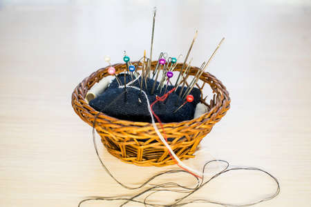 a basket with a cushion for needles, a seamstress-tailor. Needles, pinsの写真素材