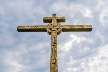 A wooden cross on top of a hill. Orthodox white