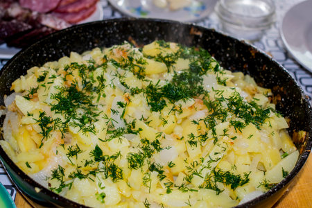 Fried potatoes on an iron frying panの写真素材