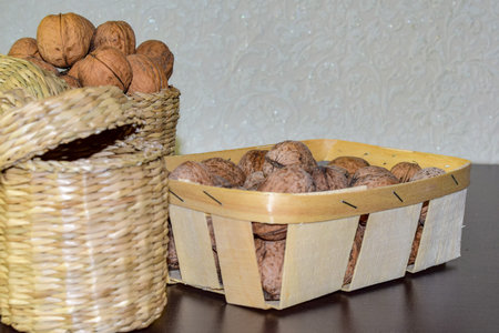 Wicker basket with walnuts among the autumn leaves