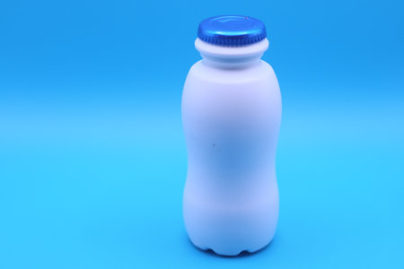 White plastic bottles are suitable for holding liquids such as milk or yoghurtの写真素材
