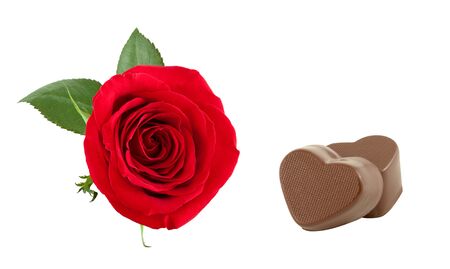 Red rose and two chocolates in the form of heart.の写真素材