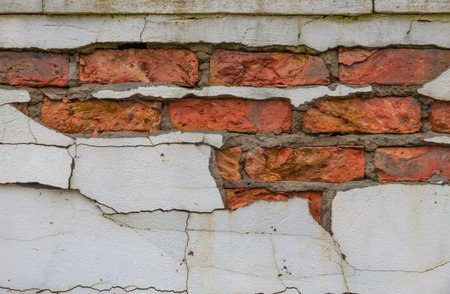 Fragment of old brick walls with pieces of plaster.の写真素材