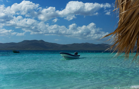 Small motor boat by the beautiful tropical islandの写真素材