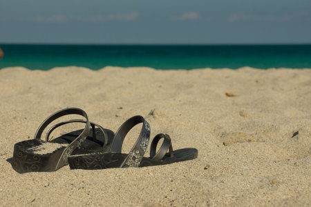 Old ladies shoes lying on the beachの写真素材