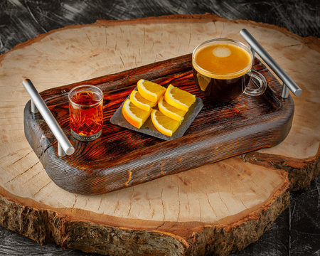 Carajillo, traditional Spanish coffee with brandy, whiskey, cognac or rum on wooden trayの写真素材