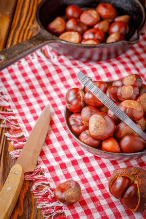 autumn still life with horse chestnuts on wooden backgroundの写真素材