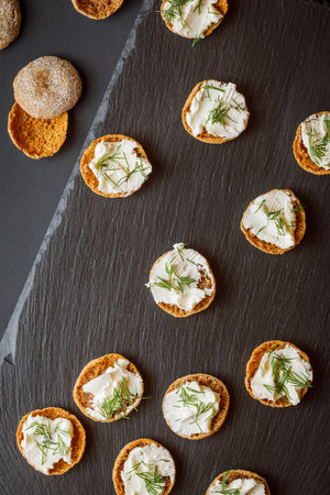 rye crispbread with cream cheese on black backgroundの写真素材