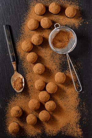 chocolate truffles or energy protein balls made with dry dates, walnuts, raisins, covered by cocoa powderの写真素材