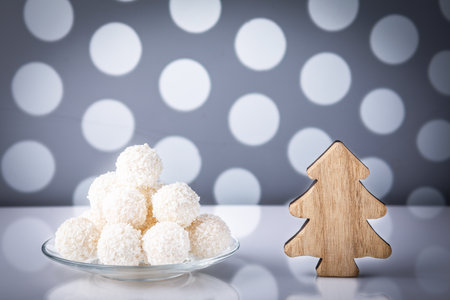 Christmas decoration and white chocolate truffles on mirror surfaceの写真素材