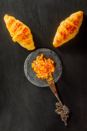 set of freshly baked croissants and orange jamの写真素材