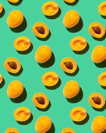 seamless pattern with apricots on green background