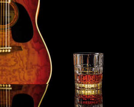 still life with whiskey and acoustic guitarの写真素材