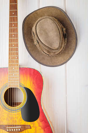 acoustic guitar and cowboy hat on wooden backgroundの写真素材