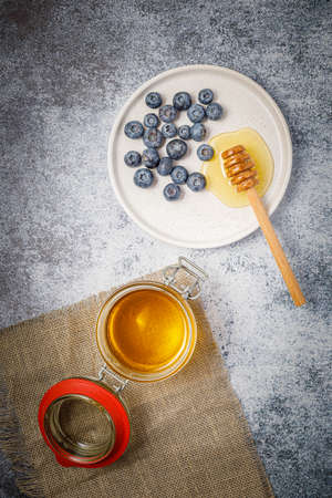 Fresh berries (blueberries and raspberries) with honeyの写真素材