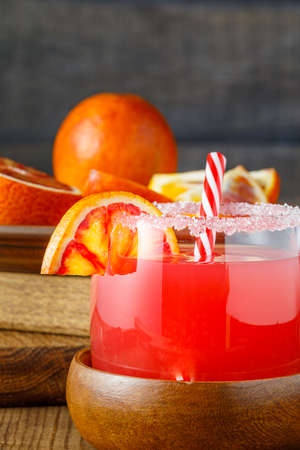 Sicilian blood oranges on wooden background. Blood orange juice with ice and orange slice.の写真素材
