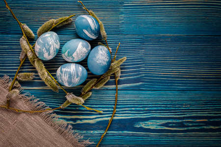 marble colored blue and white easter eggs on wooden backgroundの写真素材