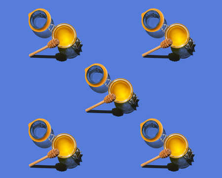 pattern background with isolated honey and honey dipperの写真素材