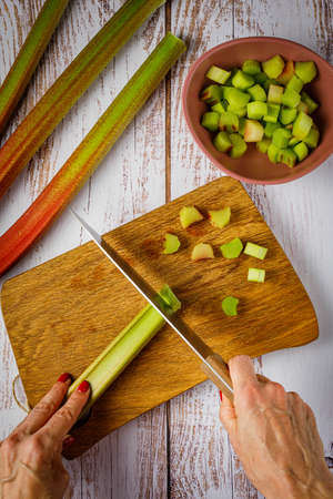 still life with fresh organic rhubarb on wooden backgroundの写真素材