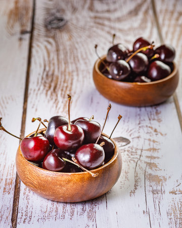 still life with fresh organic cherries and cherry juice on wooden backgroungの写真素材