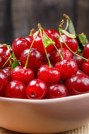 Fresh organic sour cherries on wooden background