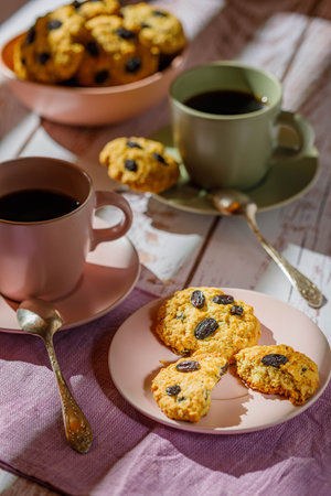 Fresh baked homemade oatmeal cookies with raisins and sunflower seeds on wooden background