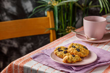Fresh baked homemade oatmeal cookies with raisins and sunflower seeds on wooden backgroundの写真素材