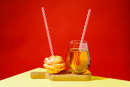 glass of apple juice and sliced apples on a tableの写真素材