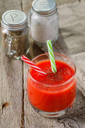 Tomato juice and sliced tomatoes on a tableの写真素材