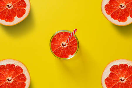 slice of red grapefruit on color backround, copy spaceの写真素材
