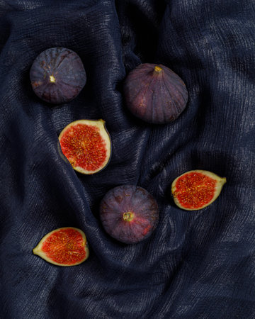 still life with figs and knife on wooden background