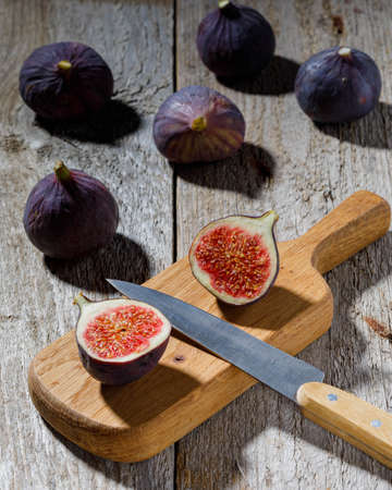 still life with figs and knife on wooden backgroundの写真素材
