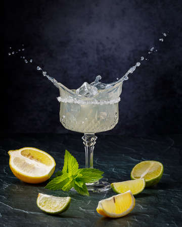 still life with glass of lemonade, lemons and mint, low key photographyの写真素材