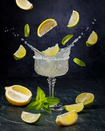 still life with glass of lemonade, lemons and mint, low key photographyの写真素材