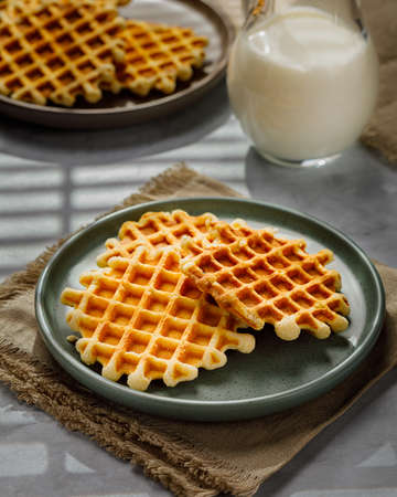 Homemade Belgium waffles served on a plate. Selective focus.の写真素材