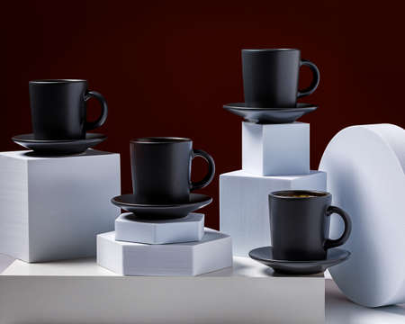 Coffee in black cup on with cubical props and lighting backgroundの写真素材